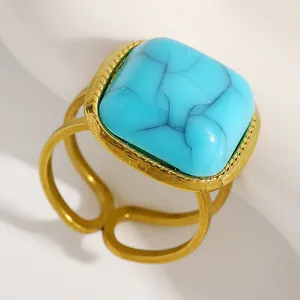 Detailed macro shot of a vintage gold adjustable ring with a large turquoise stone.