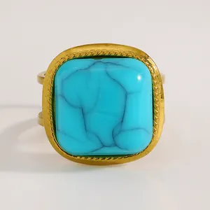 Close-up detail of a vintage bohemian adjustable gold ring featuring a square turquoise stone