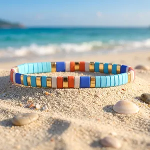 Vibrant colorful enamel stretch bracelet with mixed beads on a sandy tropical beach