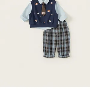 Detailed view of boys' 3-piece gentleman suit with embroidered vest and checkered pants