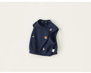 Detail view of navy blue boy's vest featuring cute dog embroidery and soft cotton fabric.