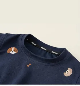 Close-up detail of navy blue round neck children's sweatshirt with cute dog and bear embroidery