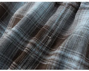Close-up macro view of the brown and blue plaid fabric texture and stitching details