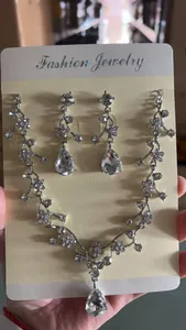 Detailed view of crystal bridal jewelry set with floral vine necklace and earrings.