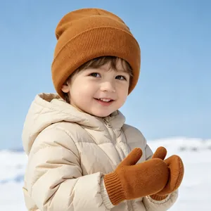 Detailed view of baby knitted beanie and mittens set in warm caramel brown for winter