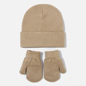 Detailed view of beige knitted baby beanie and mittens set showing soft texture
