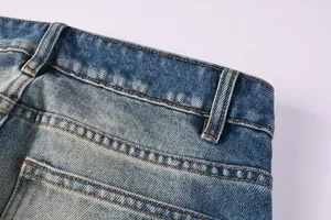 Detailed view of the waistband and stitching on slim-fit flare denim jeans for men