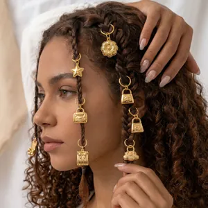Close-up of golden stainless steel hair charms with star and bag pendants in braids