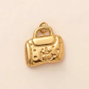 Detailed macro shot of an 18K gold plated stainless steel handbag pendant with cat design