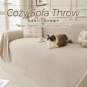 Detail view of a cream white water-repellent corduroy sofa throw with cozy texture