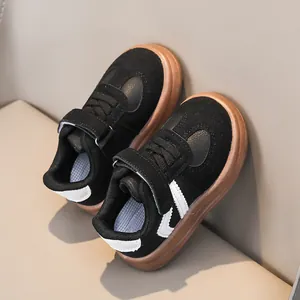 Stylish black suede toddler sneakers with soft gum soles and white wave stripe accents.
