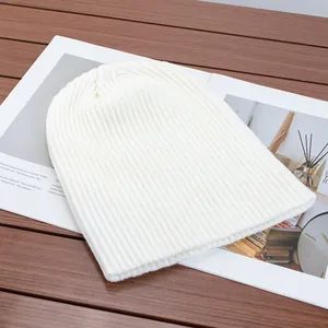 Detail view of a soft white ribbed knit beanie hat for winter warmth and style.