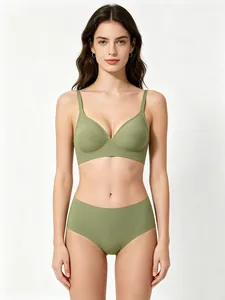 Front view of a model wearing a seamless green lingerie set featuring a jelly support bra