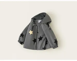 Grey hooded windbreaker for girls featuring a bold black star pattern and zipper closure.