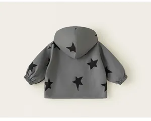Detailed back view of a grey girls' hooded windbreaker jacket featuring black star patterns