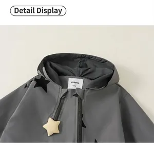 Close-up detail of grey kids windbreaker hood and star pendant zipper