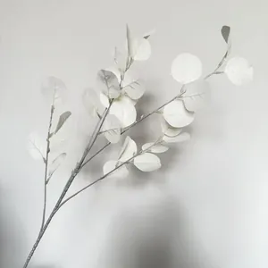 Detailed close-up of realistic white artificial eucalyptus leaves for wedding decor