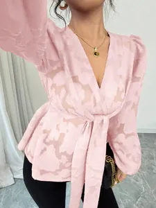 Elegant sheer pink long-sleeved V-neck blouse with floral pattern and tie-waist detail.
