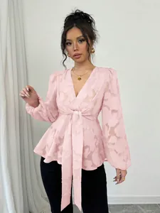Close-up of pink semi-transparent V-neck blouse with elegant tie-waist detail