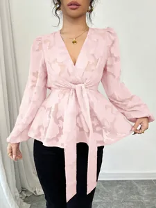 Stylish semi-transparent pink V-neck blouse with floral pattern and tie waist detail.