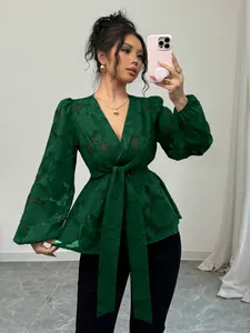 Elegant dark green burnout V-neck blouse with long puff sleeves and tie waist detail