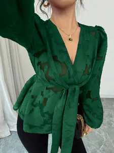 Close-up of semi-transparent green V-neck long sleeve blouse with tie-waist detail