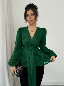 Elegant emerald green sheer V-neck blouse with tie waist and floral burnout pattern