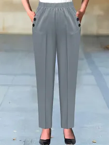 Detail of women's high-waist grey tapered dress pants with elastic waist and pockets