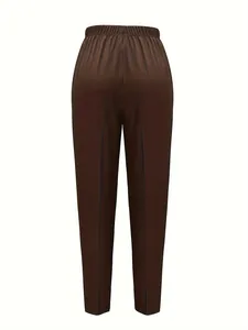 Detail showing the back design and elastic waistband of checkered tapered trousers