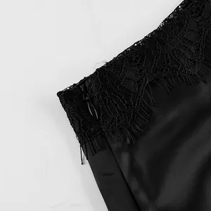 Close-up detail of black satin skirt featuring intricate lace trim and invisible zipper.