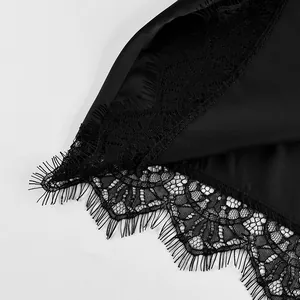 Close-up view of elegant black satin skirt featuring delicate eyelash lace trim