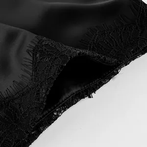 Macro detail of elegant black satin skirt with intricate eyelash lace trim border