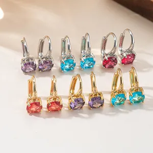 Macro detail of elegant colorful oval zircon earrings in gold and silver finishes