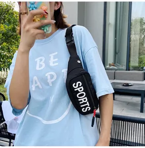Detail view of a black sports chest bag with white letter print worn by a model