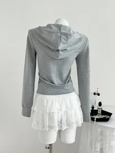 Back view of grey long sleeve zip-up hoodie paired with a white lace mini skirt on mannequin.