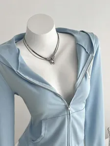 Close-up detail of a light blue women's hooded zip-up sweatshirt on a mannequin