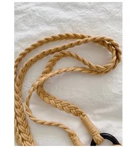 Close-up of handwoven braided strap on a retro cream shoulder bag with ring detail.