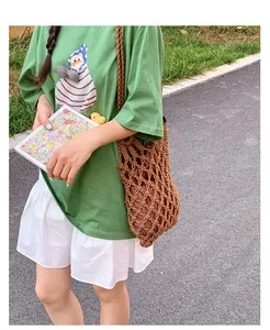 Close-up detail of a vintage brown hollow-out woven mesh shoulder bag for women