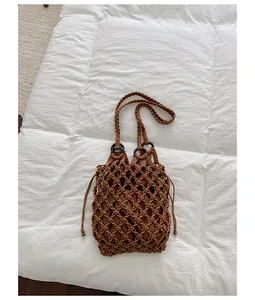 Detailed view of a retro brown woven hollow tote bag with a drawstring inner lining
