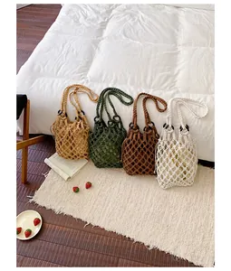Four colors of vintage handmade hollow woven grid handbags displayed on a cozy white rug
