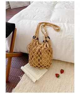 Detailed view of hand-woven macrame tote bag with inner drawstring pouch and braided handles.