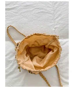 Interior view of a woven mesh bucket bag with drawstring closure and fabric lining