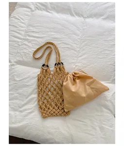 Vintage handmade hollow woven mesh tote bag with a matching inner drawstring pouch.