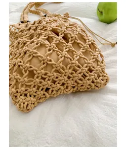 Close-up of vintage woven mesh handbag showing intricate hollow-out texture and inner pouch