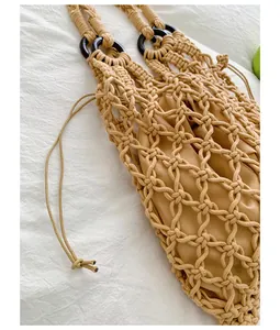 Macro view of the woven macramé mesh texture and tan drawstring inner pouch detail