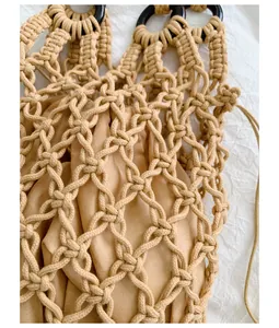 Detail of a handmade macrame hollow-out handbag featuring a beige inner drawstring pouch