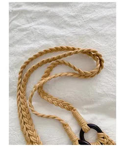 Close-up of the intricately braided rope strap on a beige woven shoulder bag