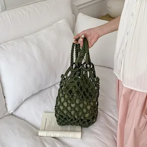 Elegant vintage green macrame hollow tote bag with unique mesh design and inner pouch.