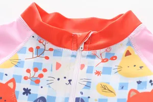 Close-up detail of the front zipper and cute cartoon cat pattern on girls' one-piece swimsuit