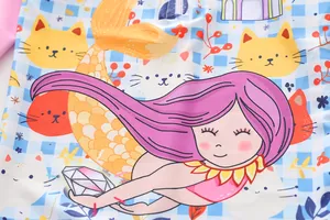 Detailed close-up showing cute cartoon mermaid and cat pattern on girls' swimwear fabric